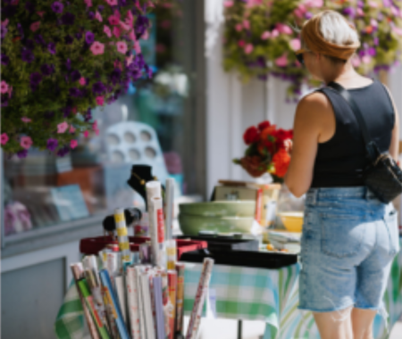 A woman shops at a sidewalk sale